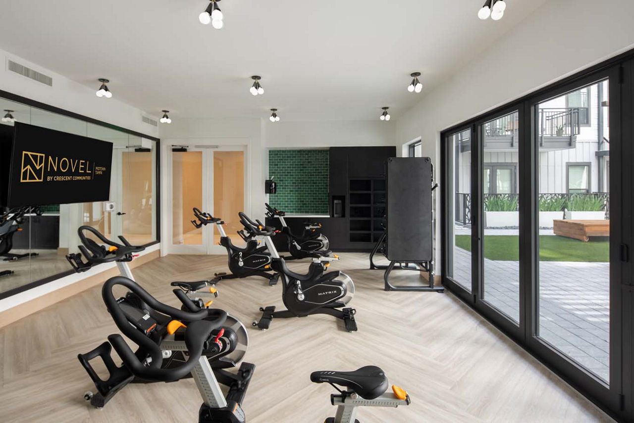 Modern yoga and spin studio featuring state-of-the-art equipment at Novel Midtown Tampa Apartments