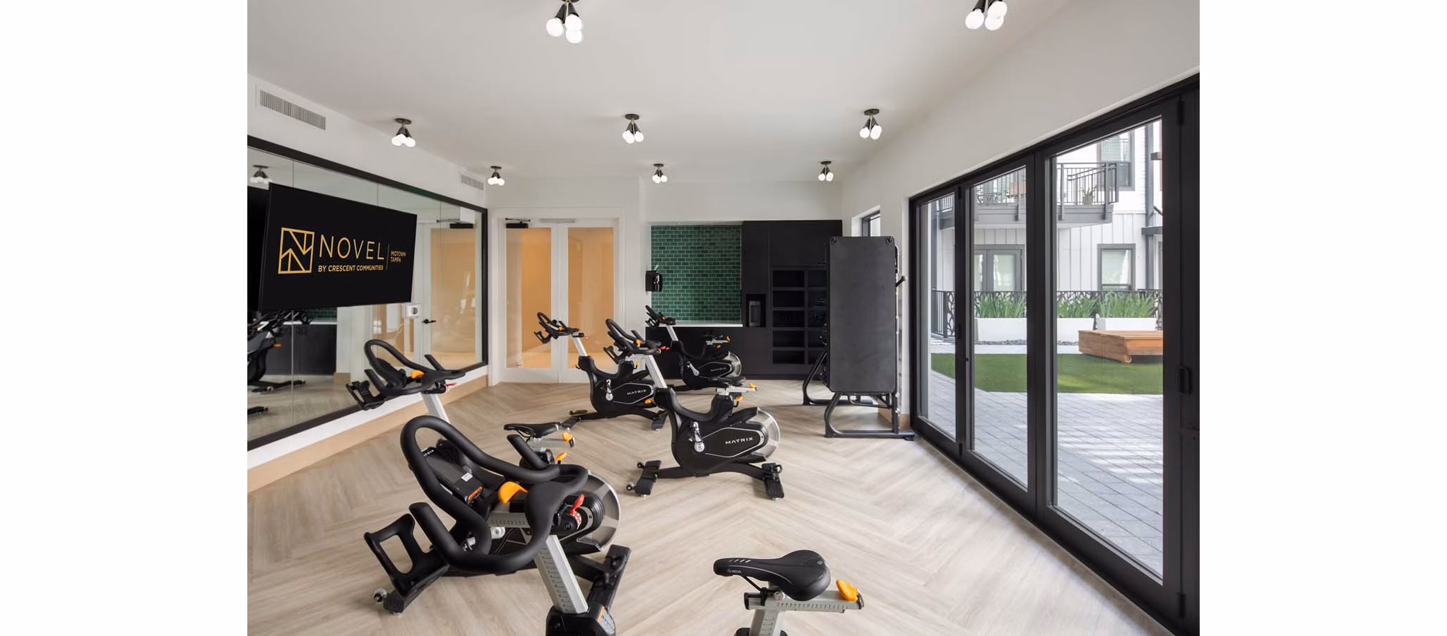 Modern yoga and spin studio featuring state-of-the-art equipment at Novel Midtown Tampa Apartments