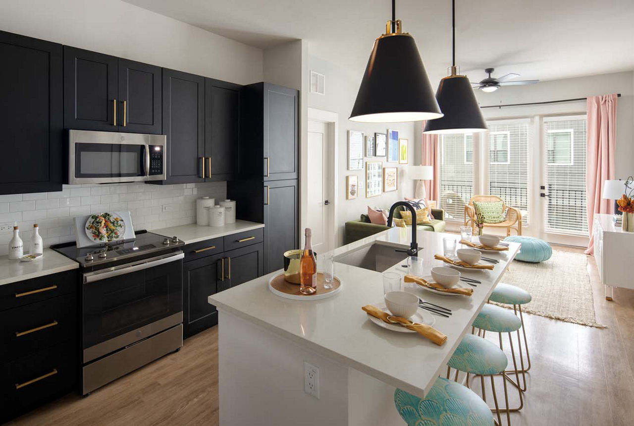 Kitchen with stainless steel appliances and granite countertops at Novel Midtown Tampa Apartments
