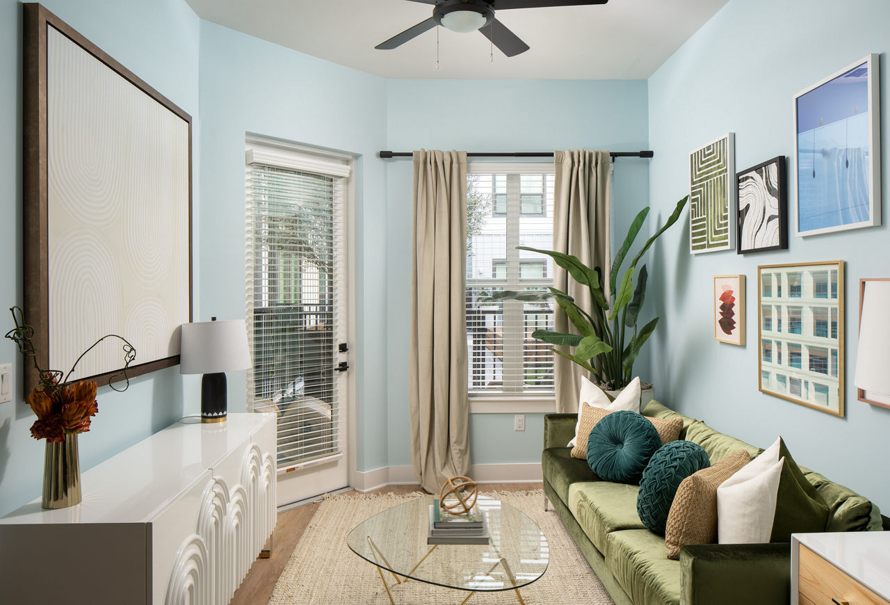 Living room with modern furnishings and large windows at Novel Midtown Tampa Apartments Luxurious and spacious apartment interior design