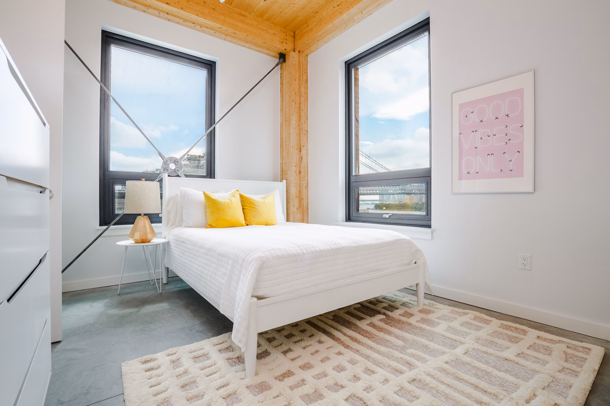 Bedroom with modern decor and natural light at 360 Wythe Apartments