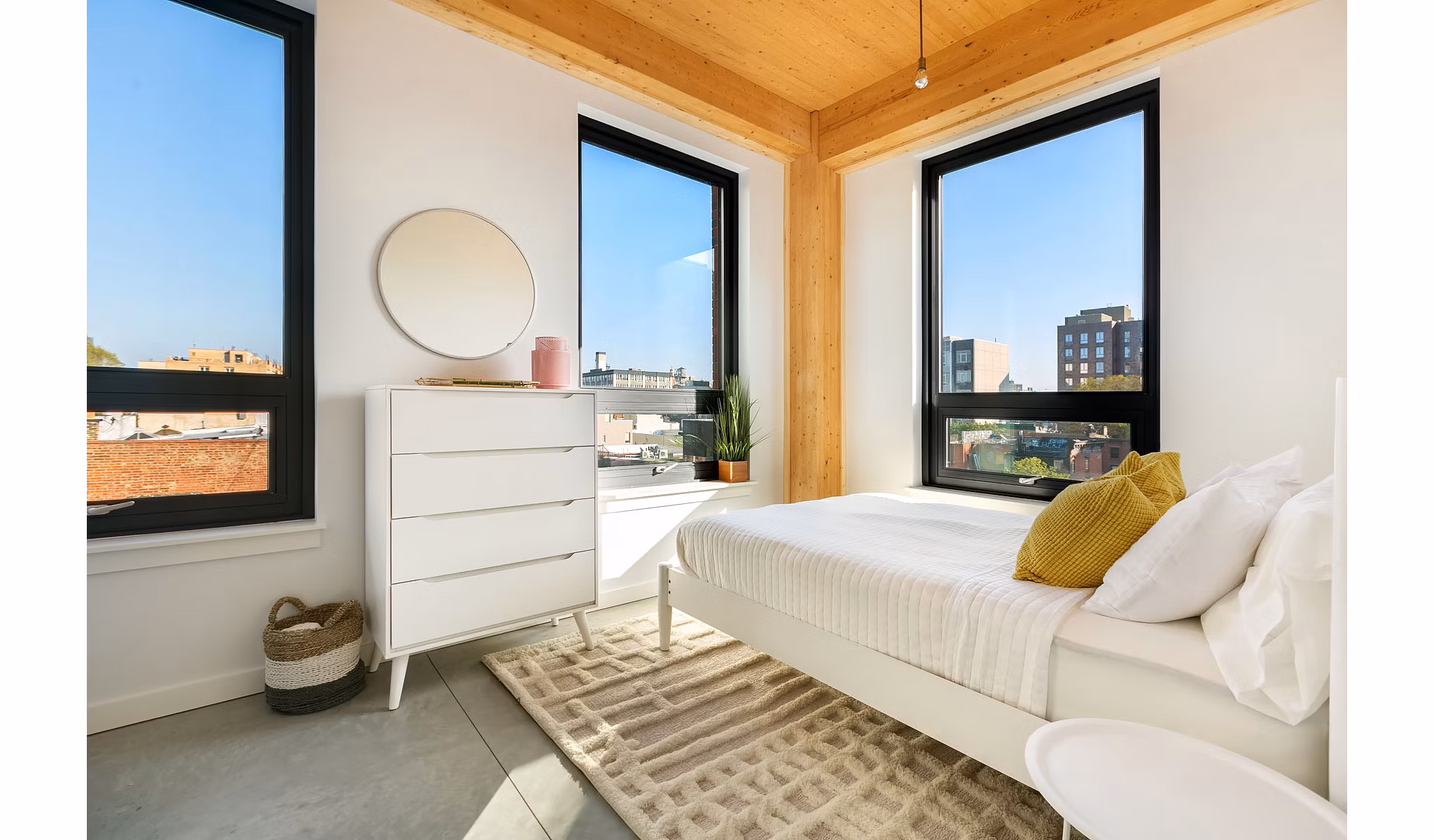 Cozy bedroom with plush bedding and modern decor at 360 Wythe Apartments in Brooklyn