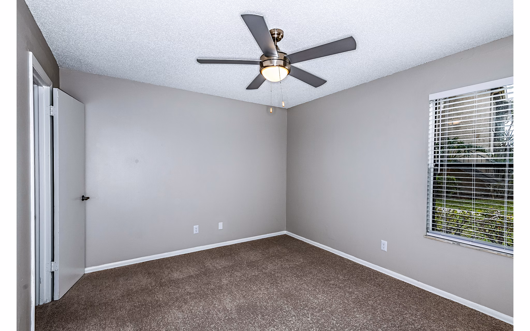 Cozy bedroom with modern decor at Heron Lake Apartments featuring tranquil lake views