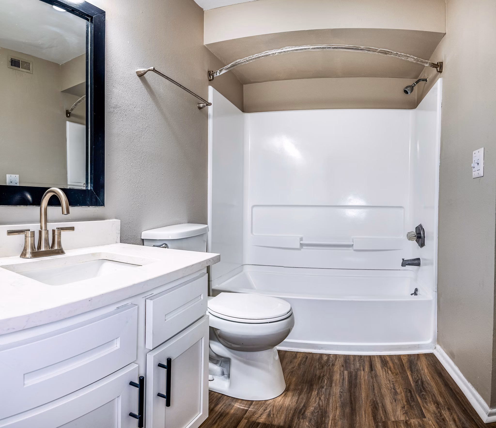 Bathroom with modern fixtures and elegant accents at Heron Lake Apartments, offering luxury living in a serene environment