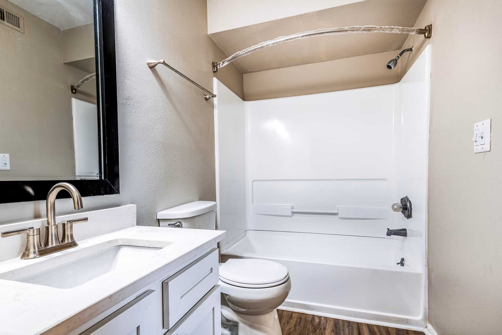 Bathroom featuring sleek fixtures and marble countertops at Heron Lake Apartments, luxury rental by Greystar