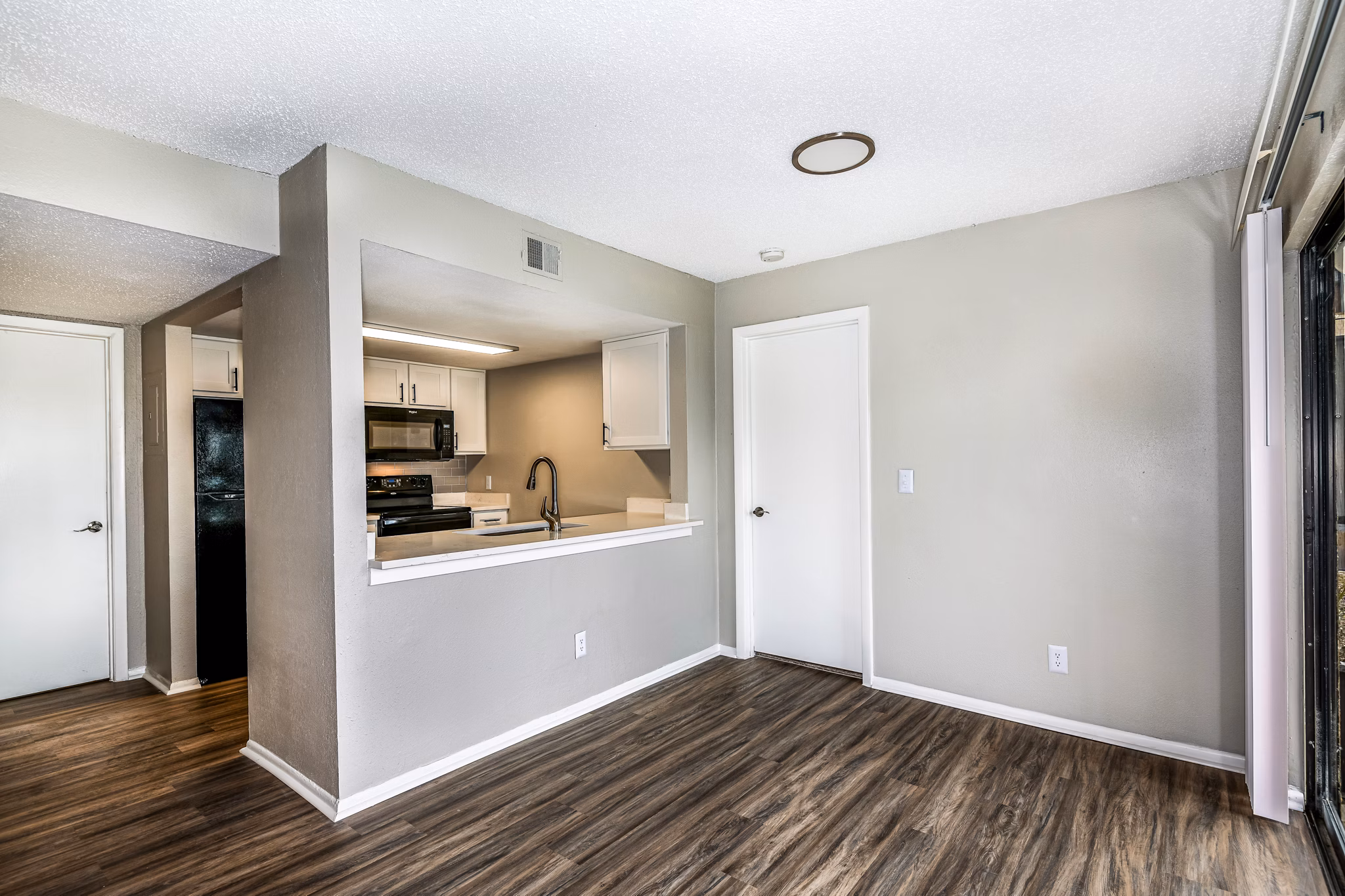 Dining room and entry with modern decor in Heron Lake Apartments, showcasing luxury living spaces in a Greystar community