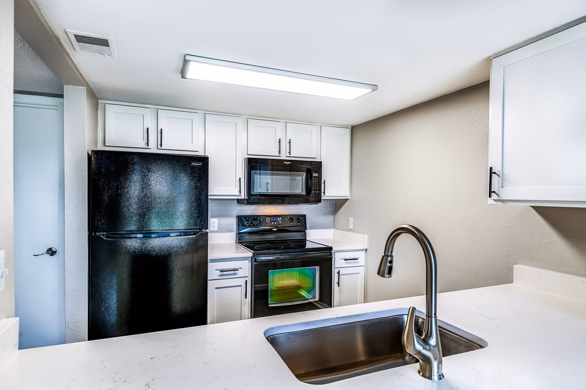 Modern kitchen with stainless steel appliances at Heron Lake Apartments