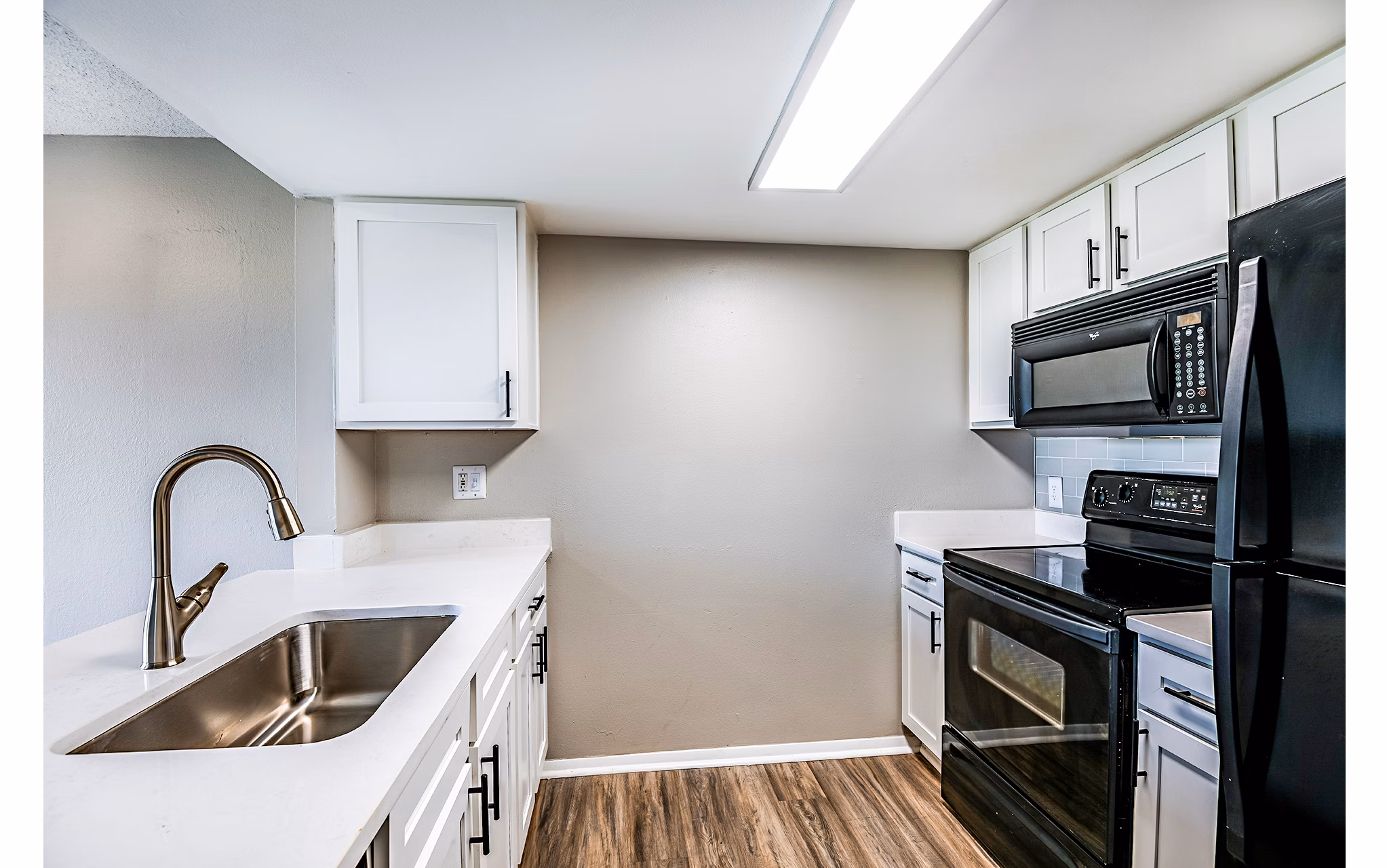 Modern kitchen with stainless steel appliances at Heron Lake Apartments