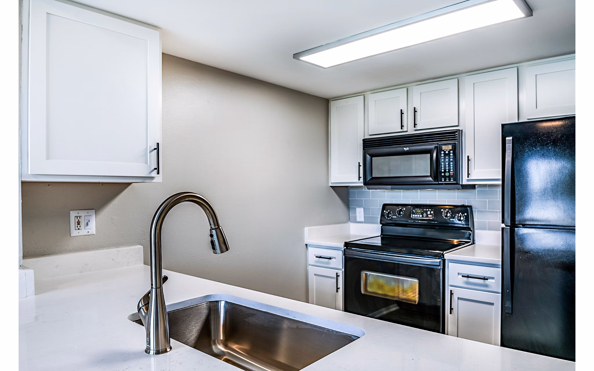 Modern kitchen featuring stainless steel appliances at Heron Lake Apartments