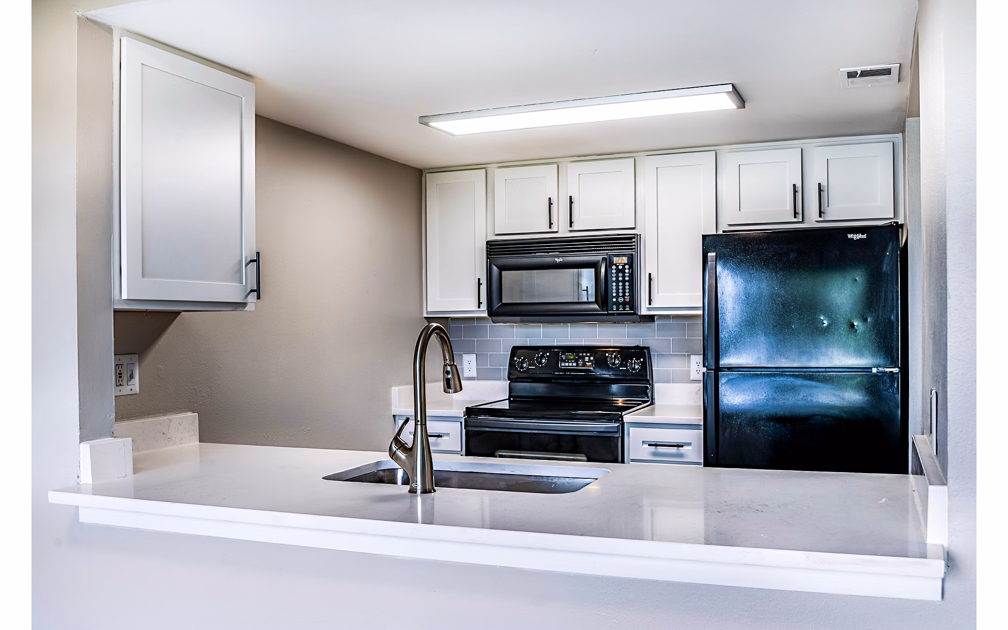 Modern kitchen with stainless steel appliances at Heron Lake Apartments, featuring a spacious island perfect for cooking and entertaining