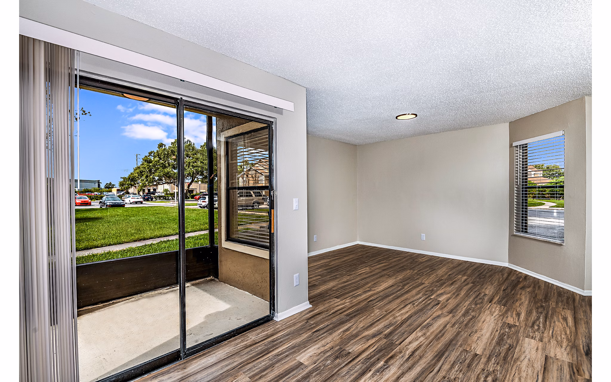 Spacious living room with modern decor and large windows at Heron Lake Apartments