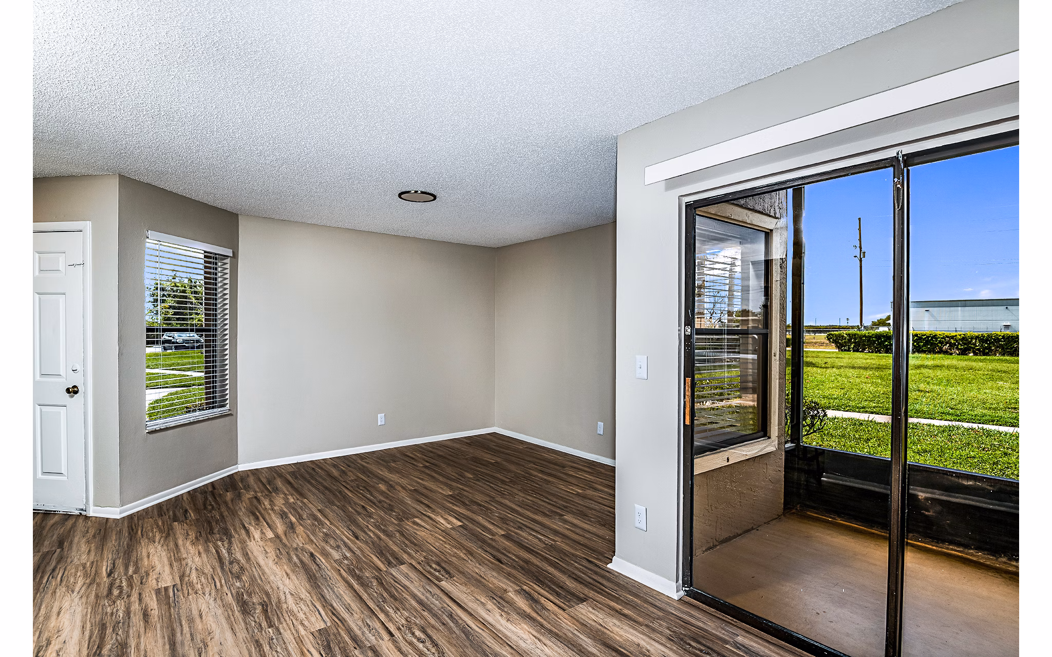 Spacious living room with plush seating and large windows in Heron Lake Apartments