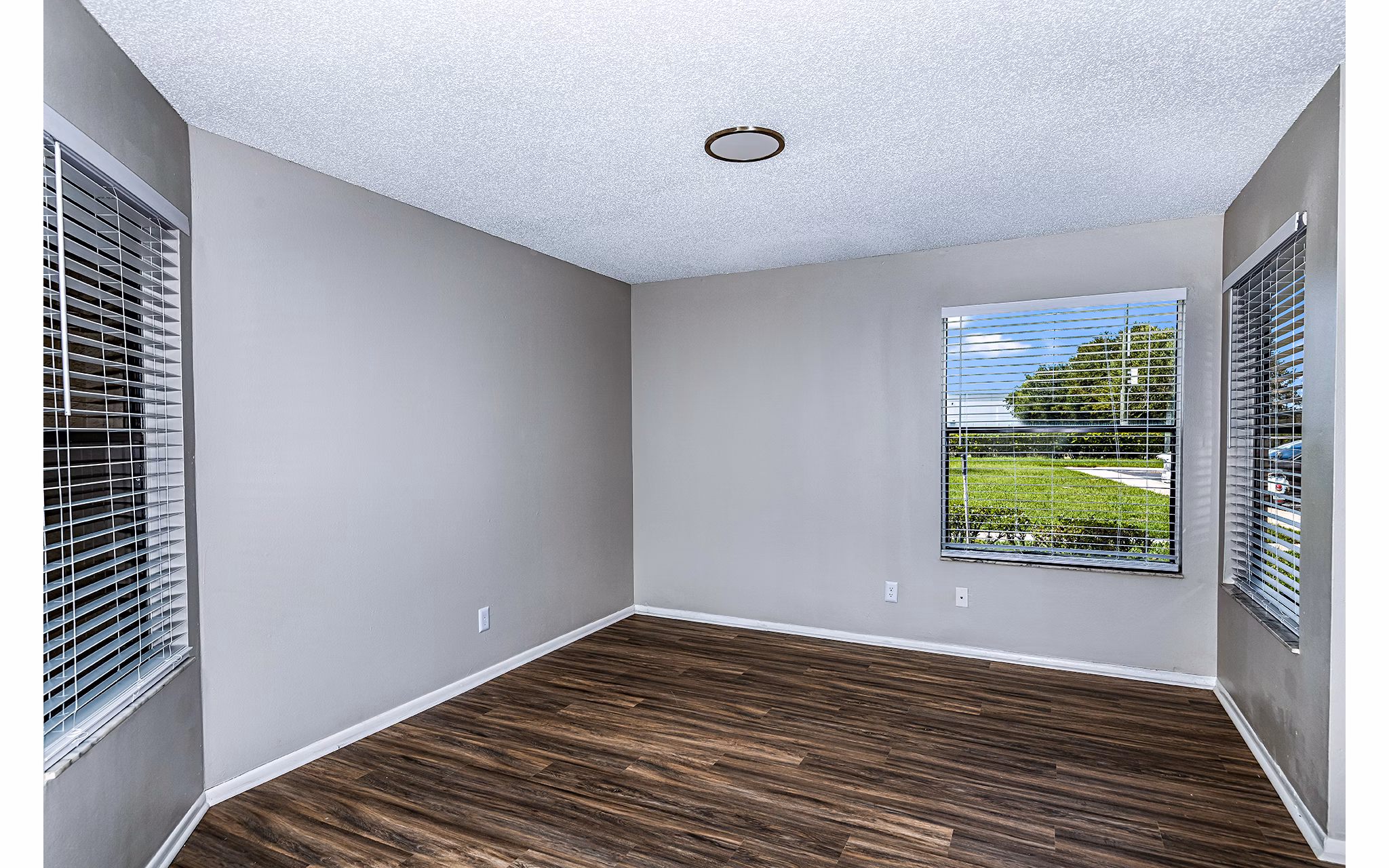 Living room with elegant furnishings and lake views at Heron Lake Apartments