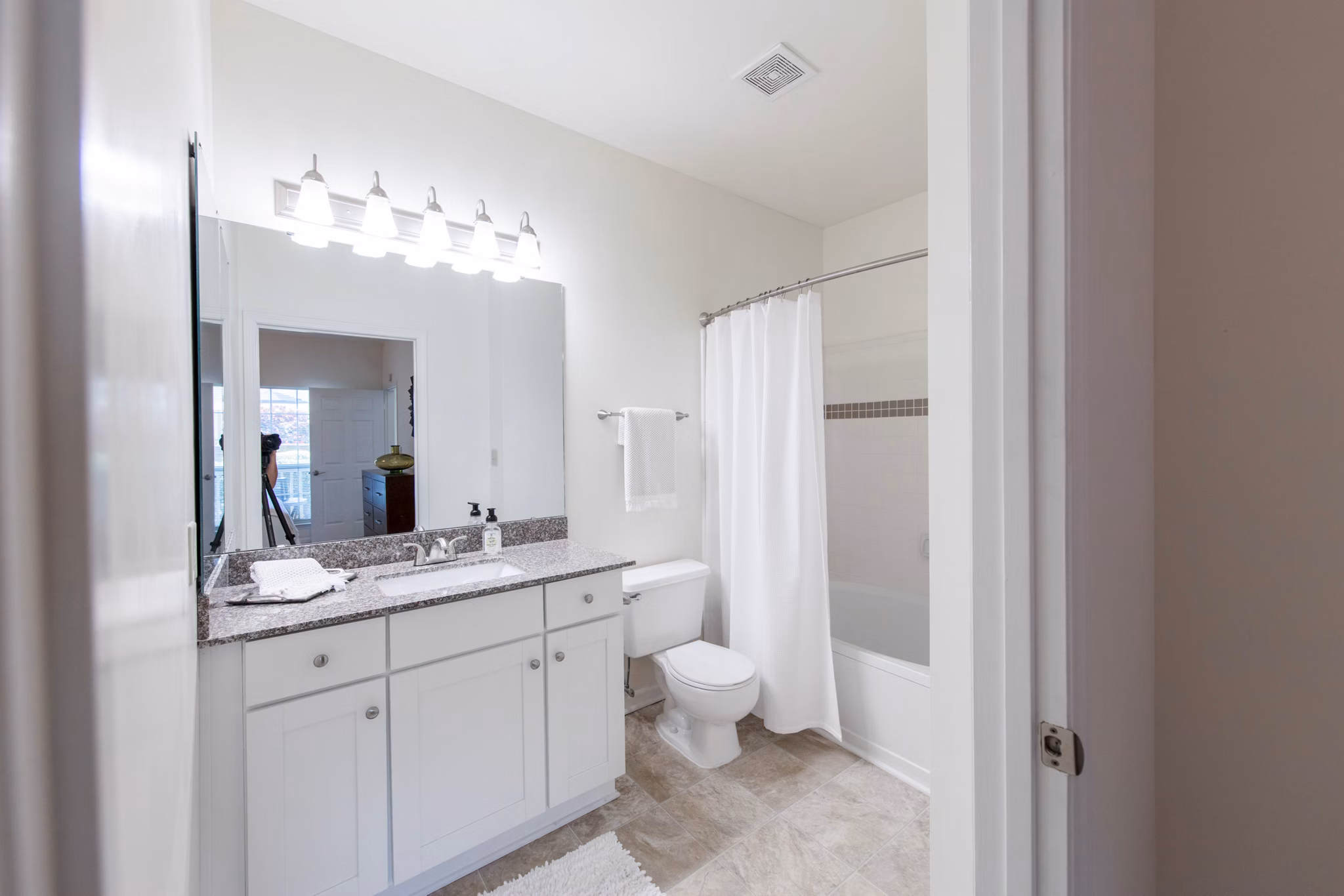 Bathroom featuring sleek design and modern fixtures in 42 Magnolia at 5000 Forest Apartments