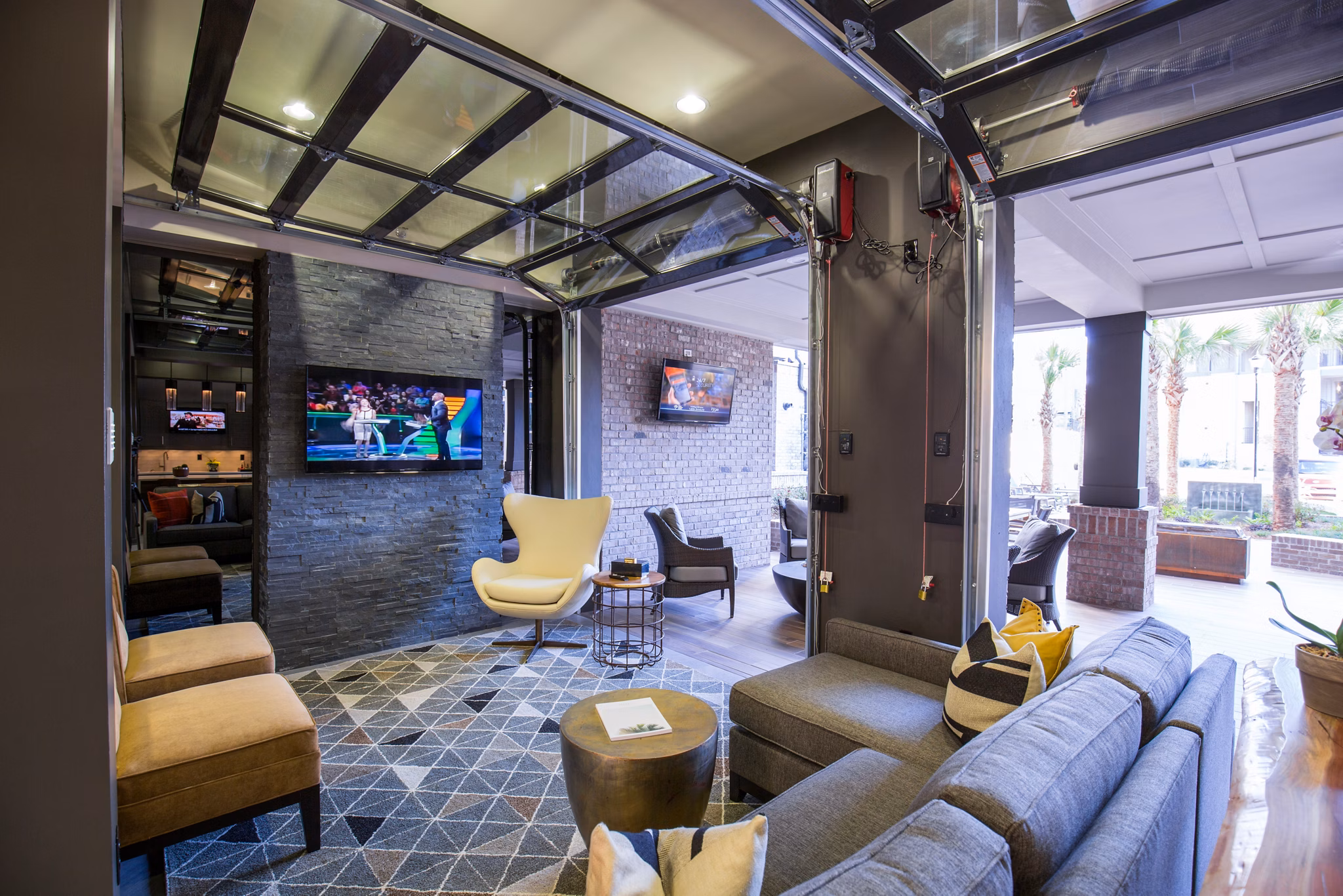 Outdoor patio with seating and lush greenery at 42 Magnolia and 5000 Forest luxury apartments