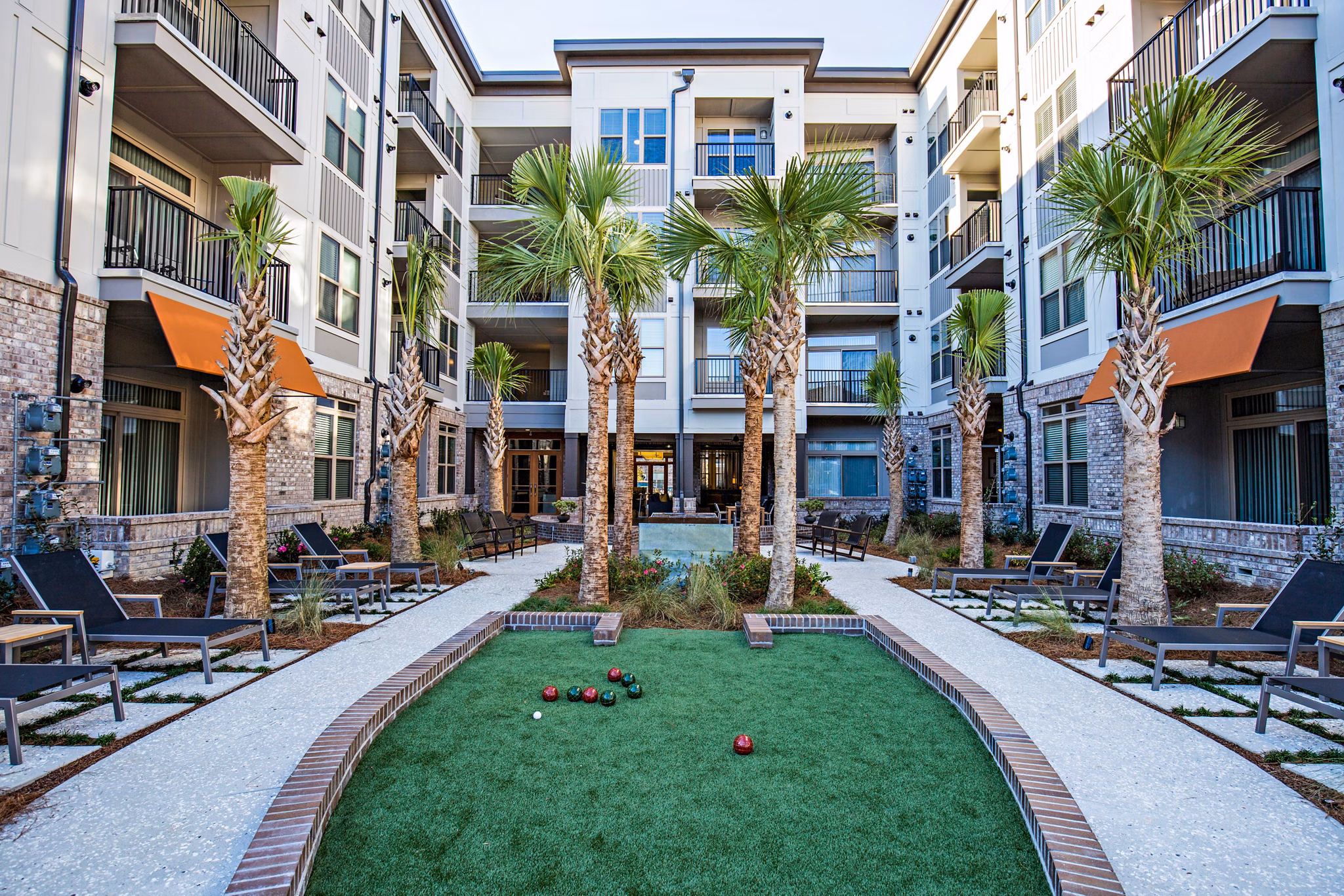 Bocce court surrounded by lush gardens at 42 Magnolia and 5000 Forest Apartments, offering recreational activities for residents