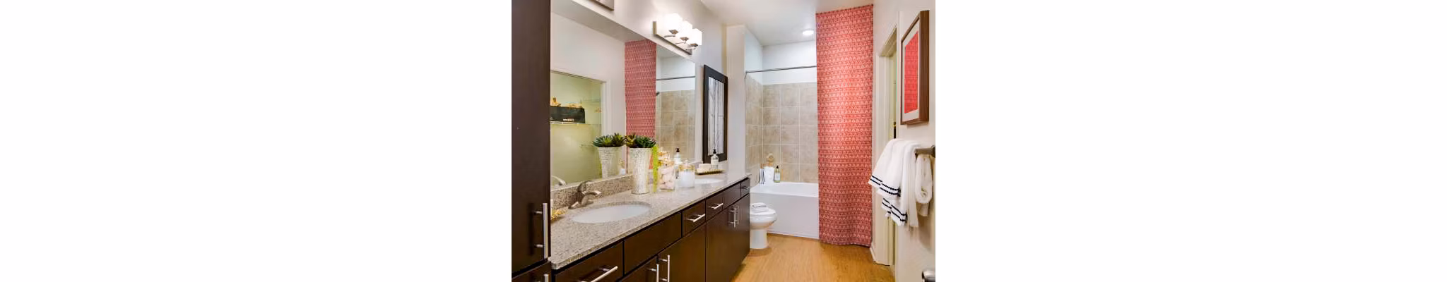 Bathroom featuring modern fixtures and marble countertops in Tapestry at Lake Park Apartments