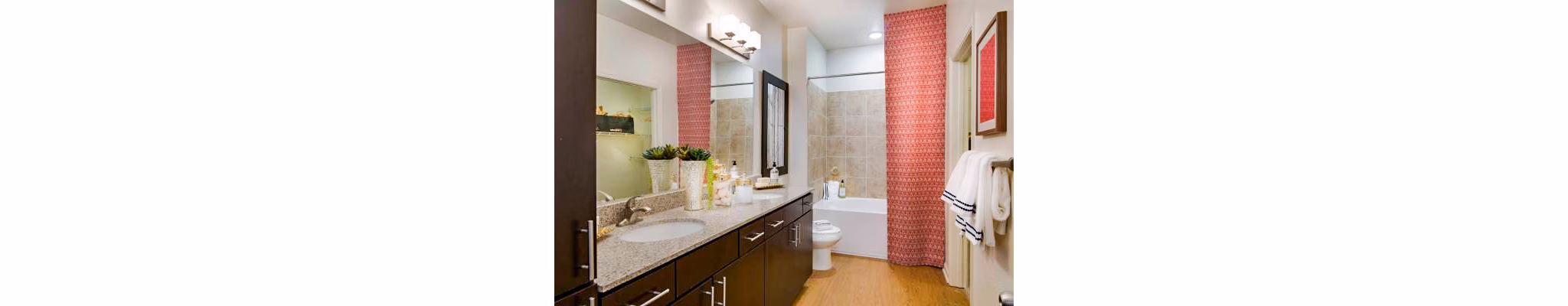 Bathroom featuring modern fixtures and marble countertops in Tapestry at Lake Park Apartments