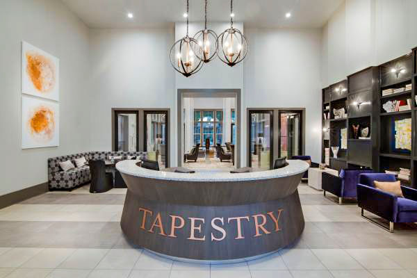 Clubhouse lobby with modern seating and decor at Tapestry at Lake Park Apartments