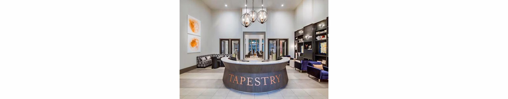 Clubhouse lobby with modern seating and decor at Tapestry at Lake Park Apartments