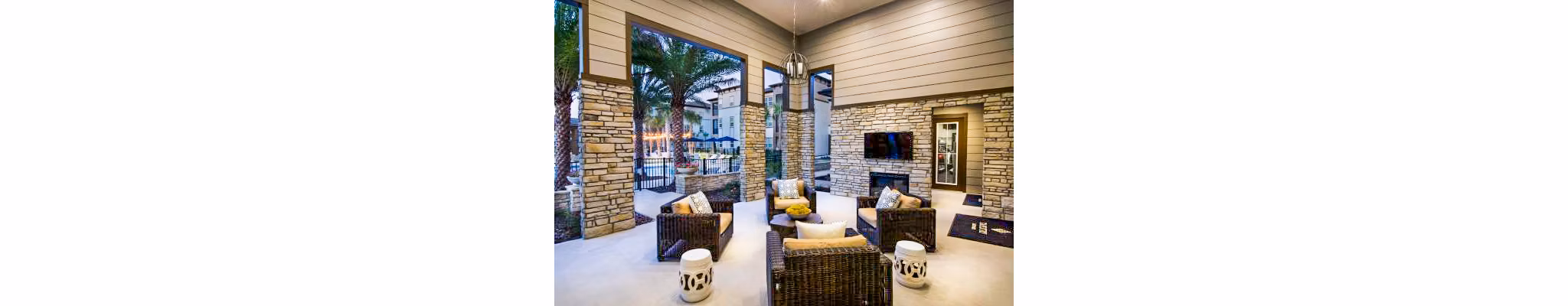 Patio with outdoor seating and lush landscaping at Tapestry at Lake Park Apartments