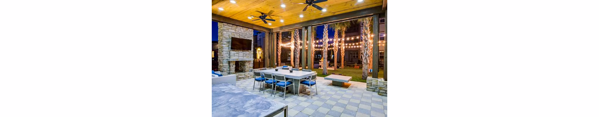 Tapestry at Lake Park Apartments: Relaxing patio with outdoor seating and lush greenery