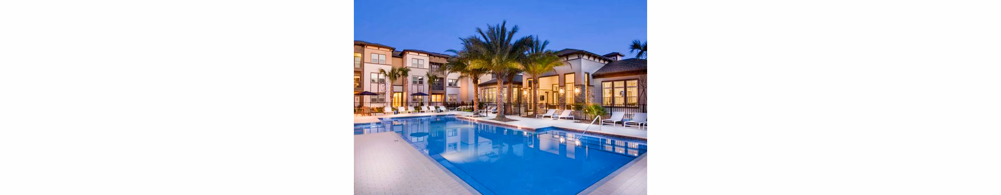 Resort-style pool with sundeck at Tapestry at Lake Park Apartments, offering luxury living amenities in a serene environment
