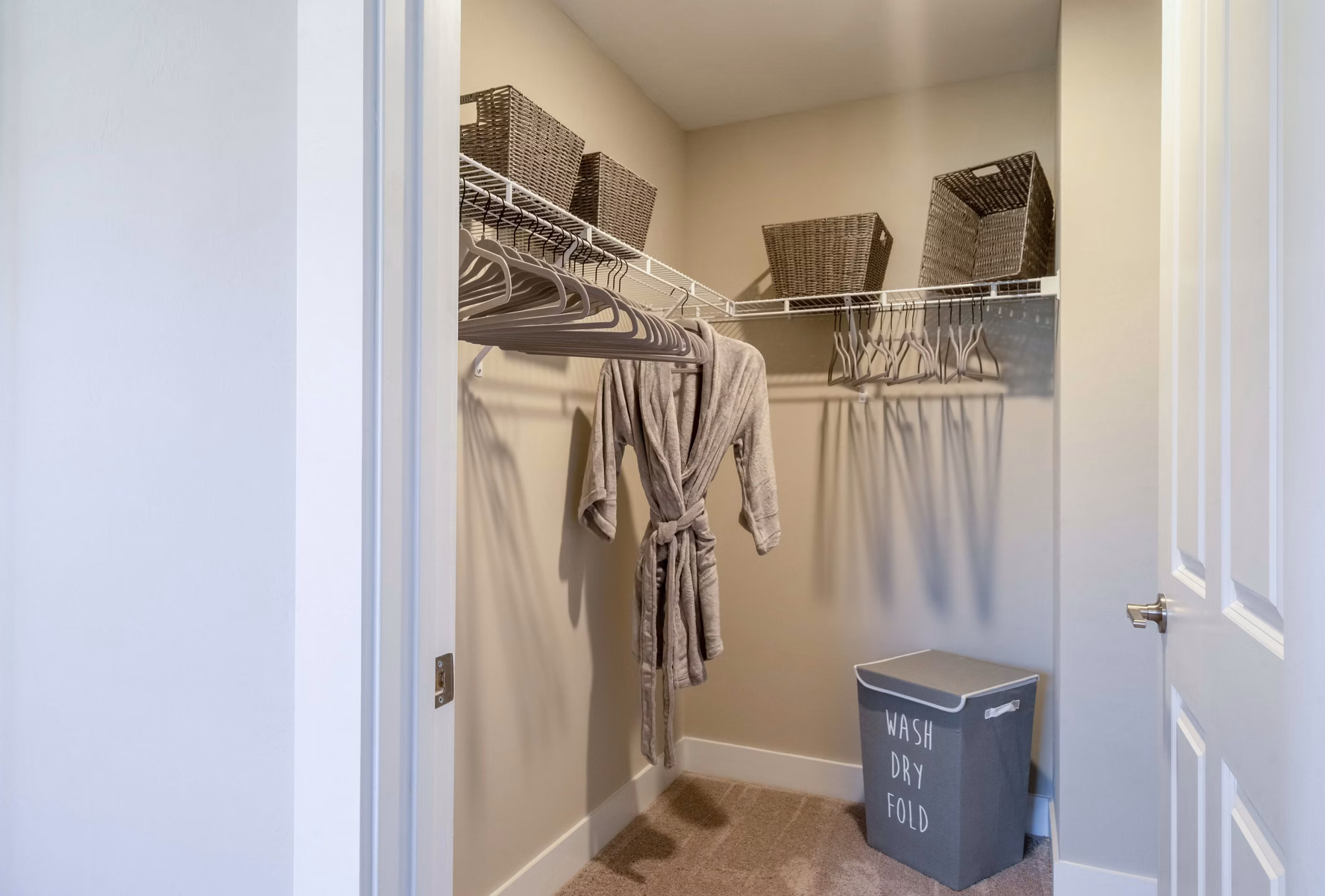 Walk-in closet with built-in shelving at The Palms at Cape Coral Apartments, offering ample storage space for luxury living