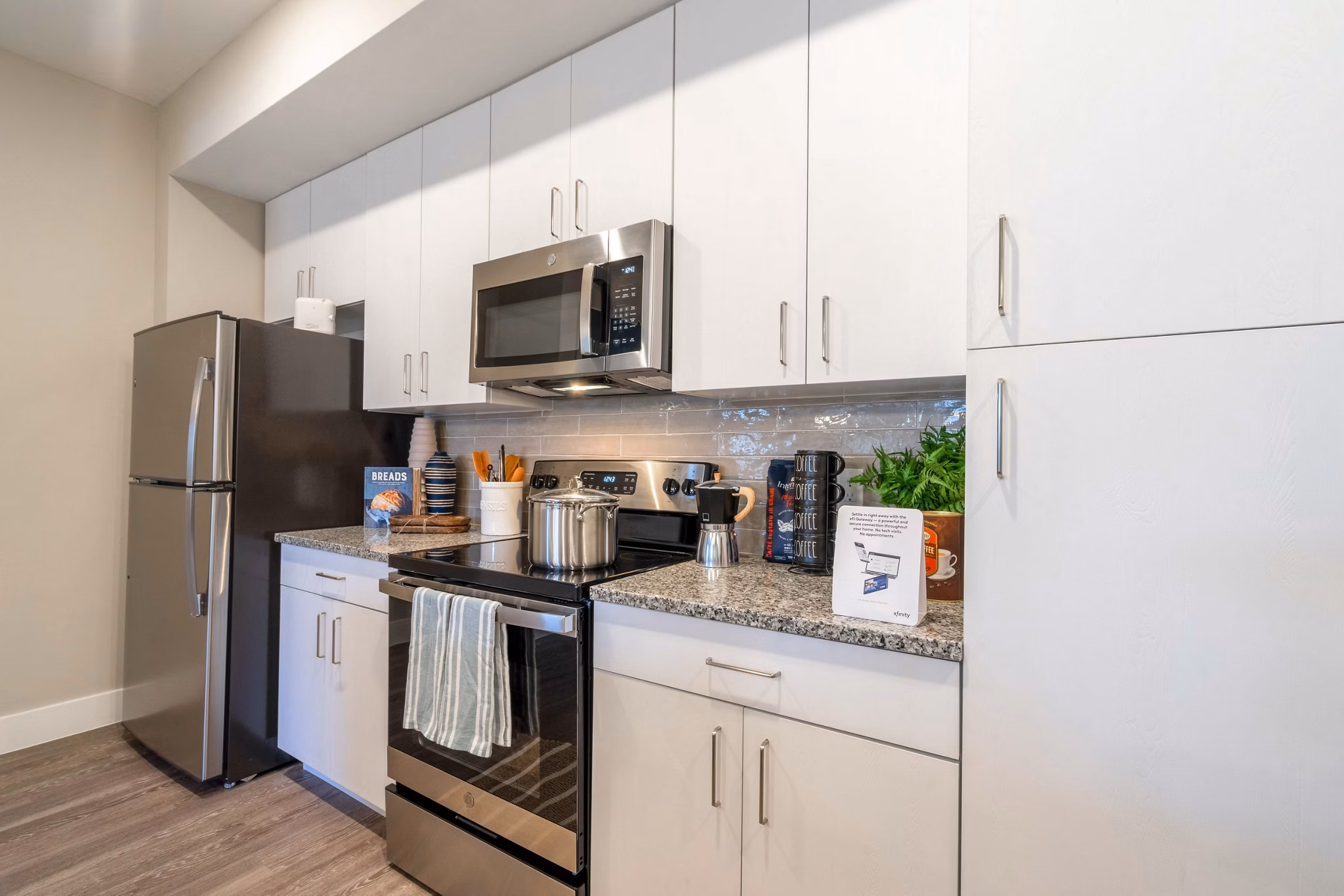 Modern kitchen with stainless steel appliances in The Palms at Cape Coral Apartments luxury housing
