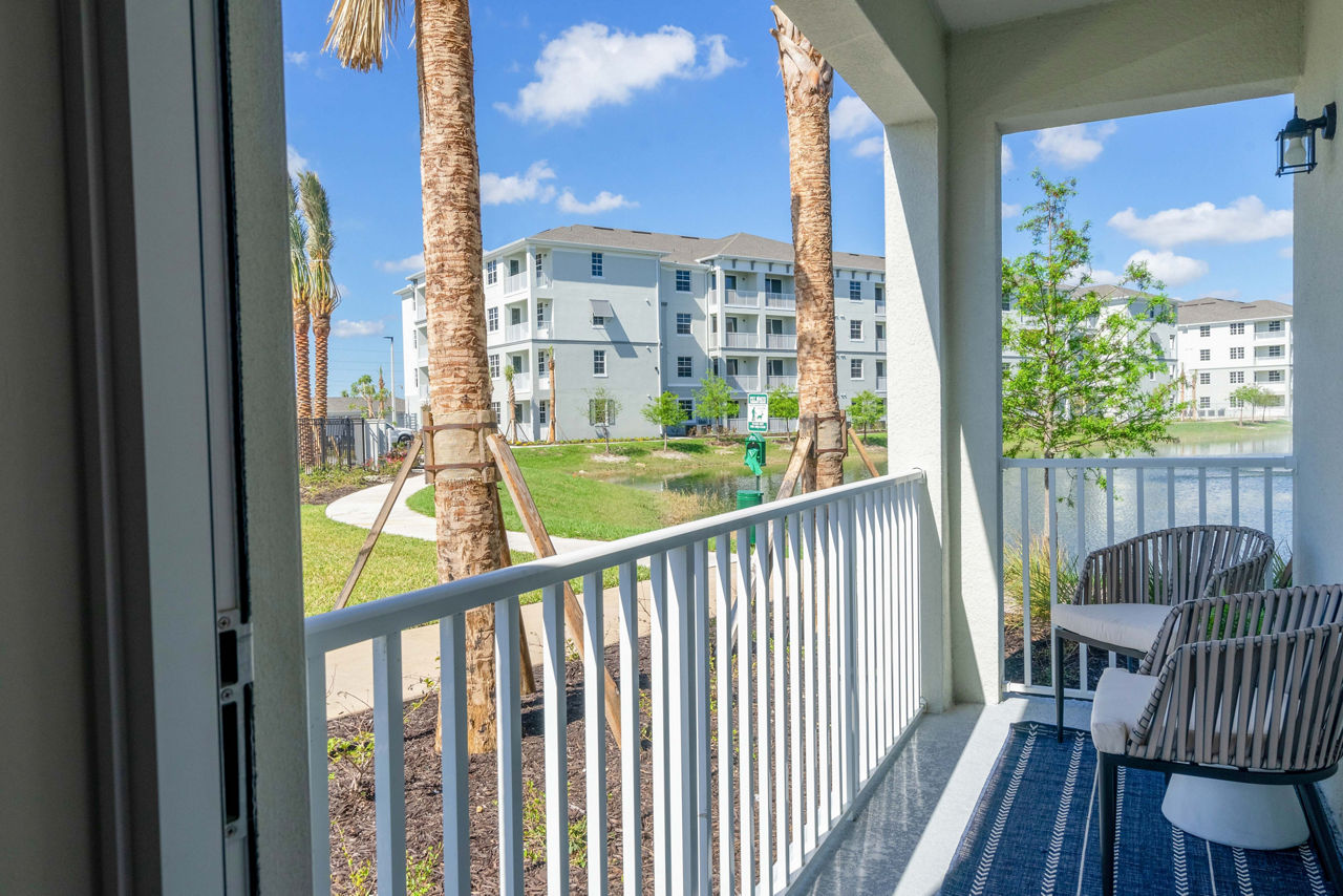 Patio at The Palms at Cape Coral Apartments featuring outdoor seating and lush landscaping, offering a serene relaxation spot