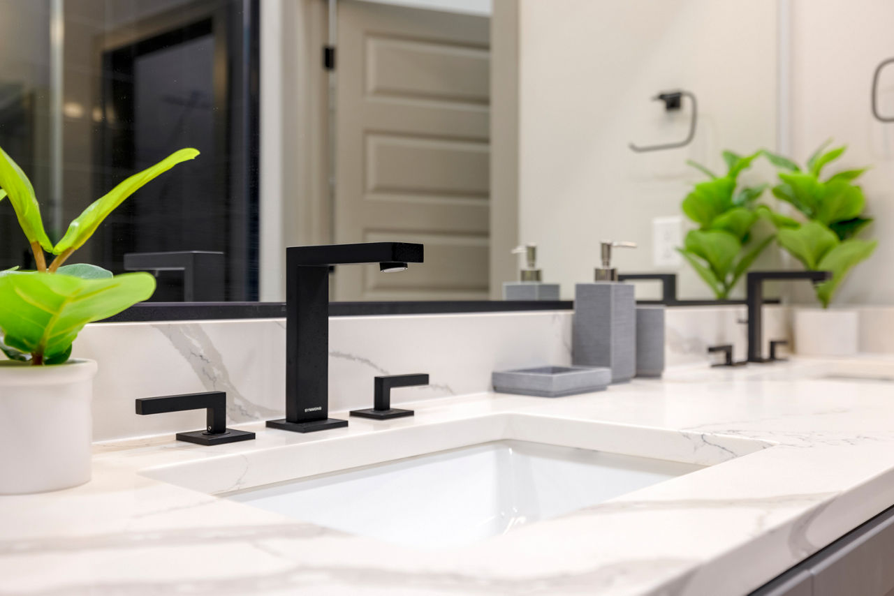 Luxurious bathroom with modern fixtures at Marlow Apartments, featuring elegant tile work and spacious vanity