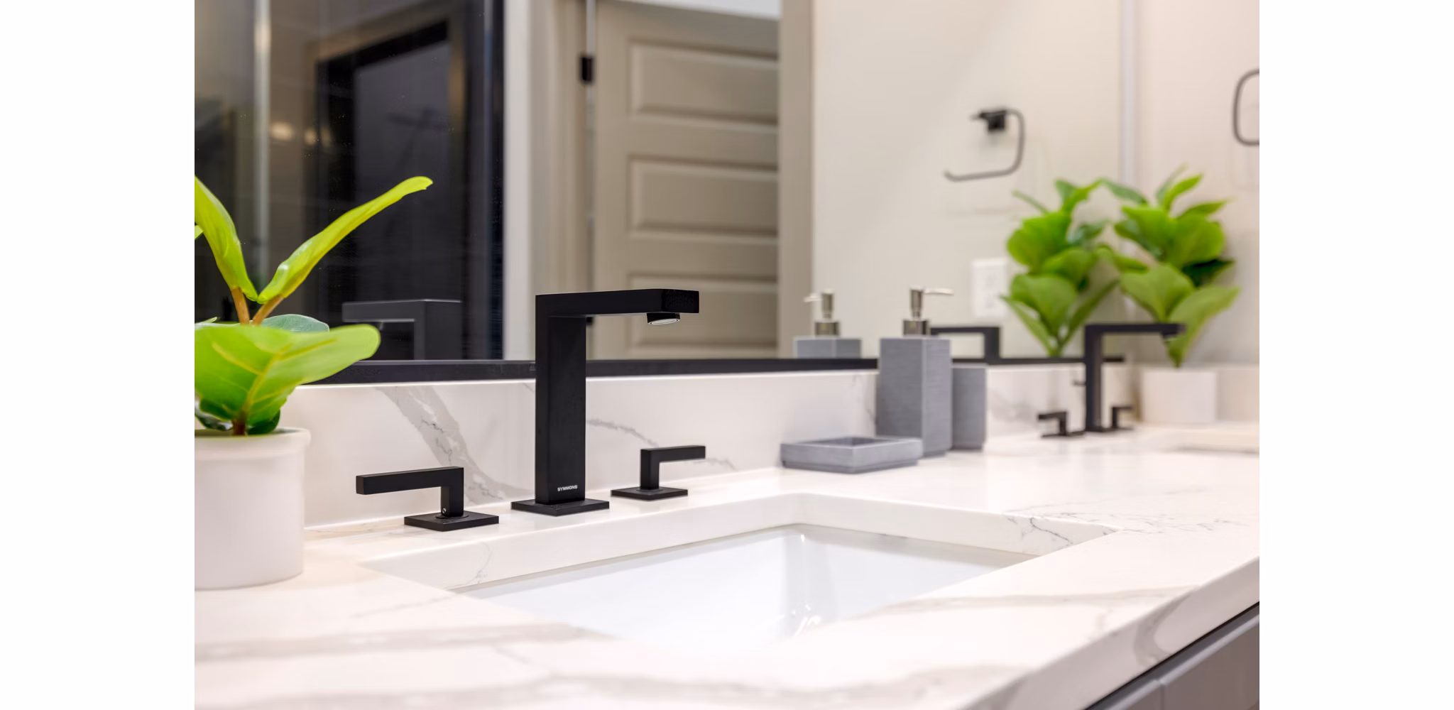 Luxurious bathroom with modern fixtures at Marlow Apartments, featuring elegant tile work and spacious vanity