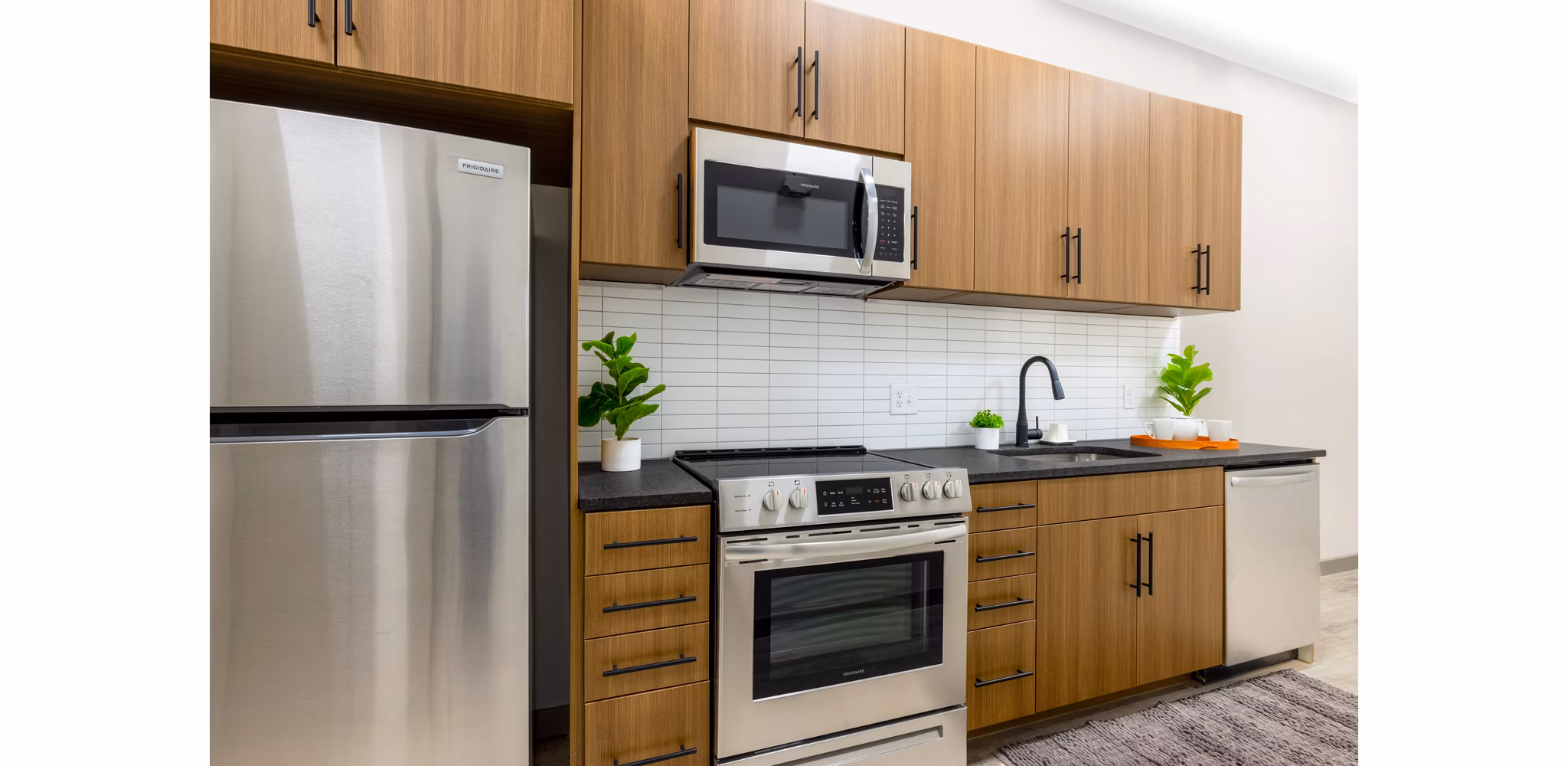 Modern kitchen with stainless steel appliances and sleek countertops in Marlow Apartments