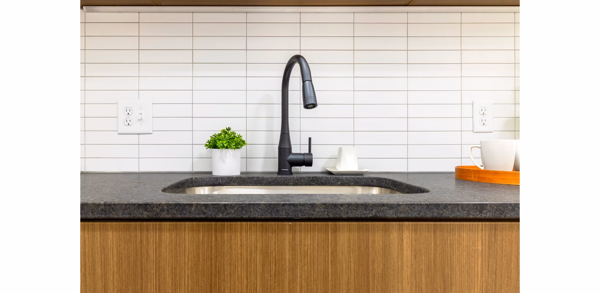 Modern kitchen with stainless steel appliances and quartz countertops at Marlow Apartments, luxury living in Columbia, MD.