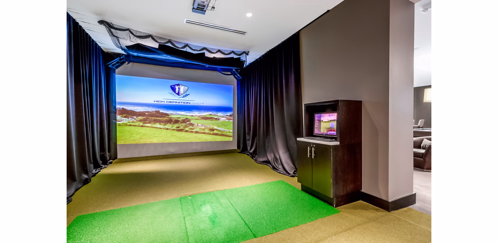 Virtual putting green at Esplanade at National Harbor Apartments featuring realistic turf and ambient lighting