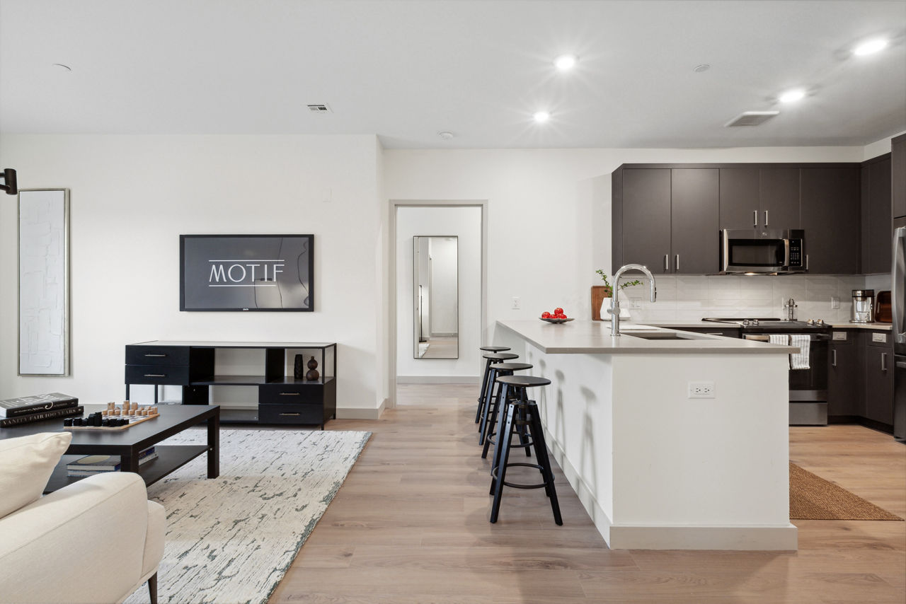 Elegant kitchen with marble countertops and stainless steel appliances in Motif Apartments luxury living space