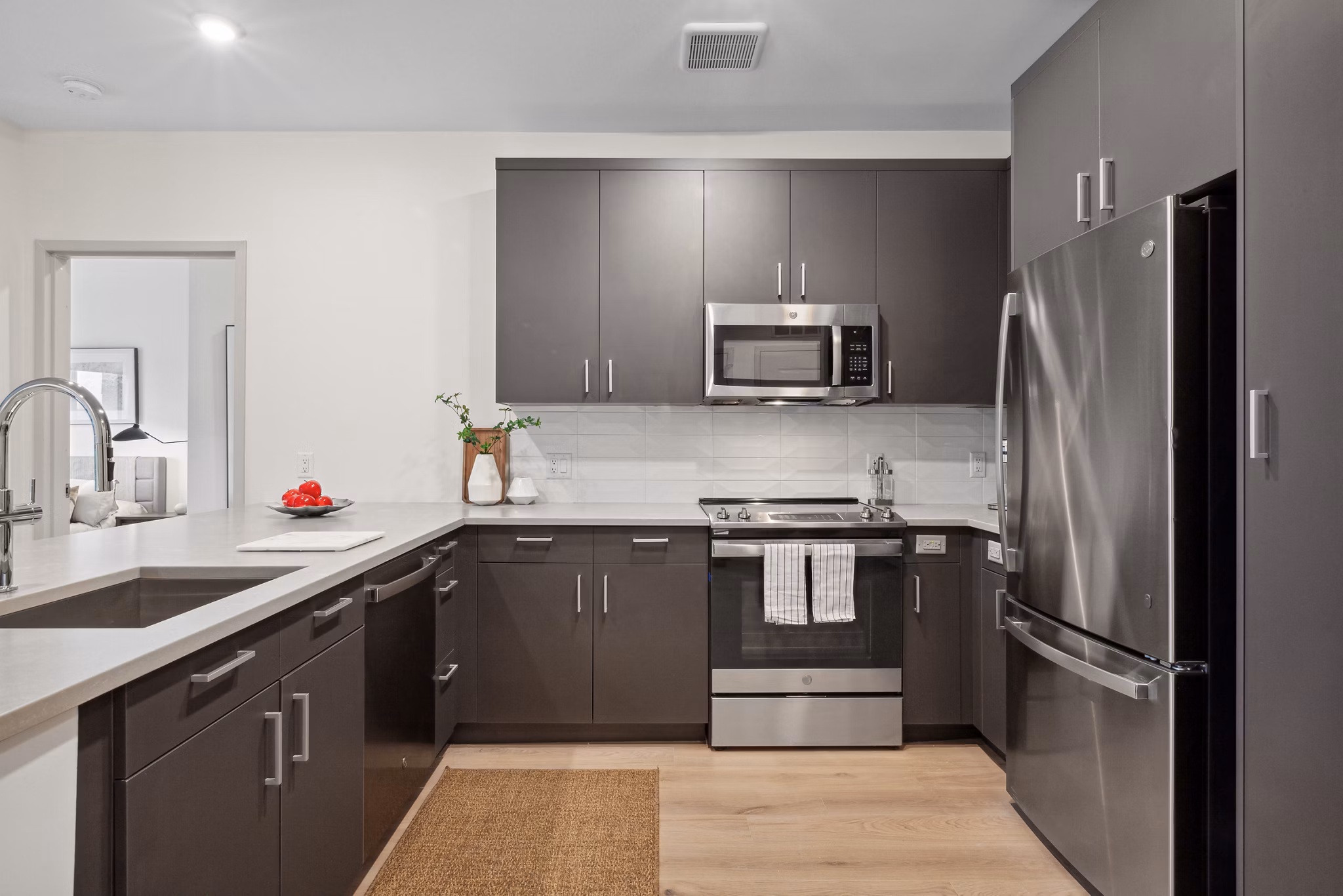 Modern kitchen with stainless steel appliances at Motif Apartments, featuring luxury finishes and sleek cabinetry for stylish living