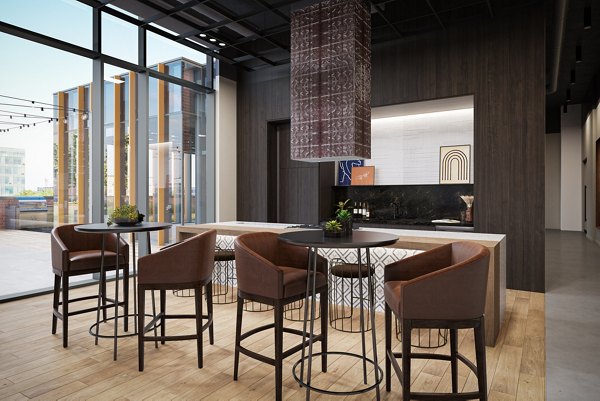Clubhouse featuring modern design and ample seating at One Six Six Apartments