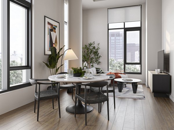 Dining area with modern furnishings at One Six Six Apartments, featuring elegant lighting and spacious seating arrangement