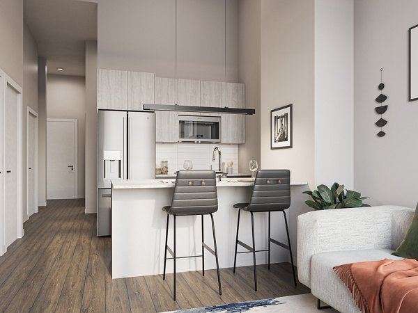 Modern kitchen with stainless steel appliances at One Six Six Apartments