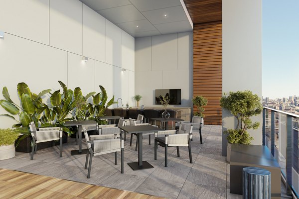 Outdoor patio with modern seating and greenery at One Six Six Apartments