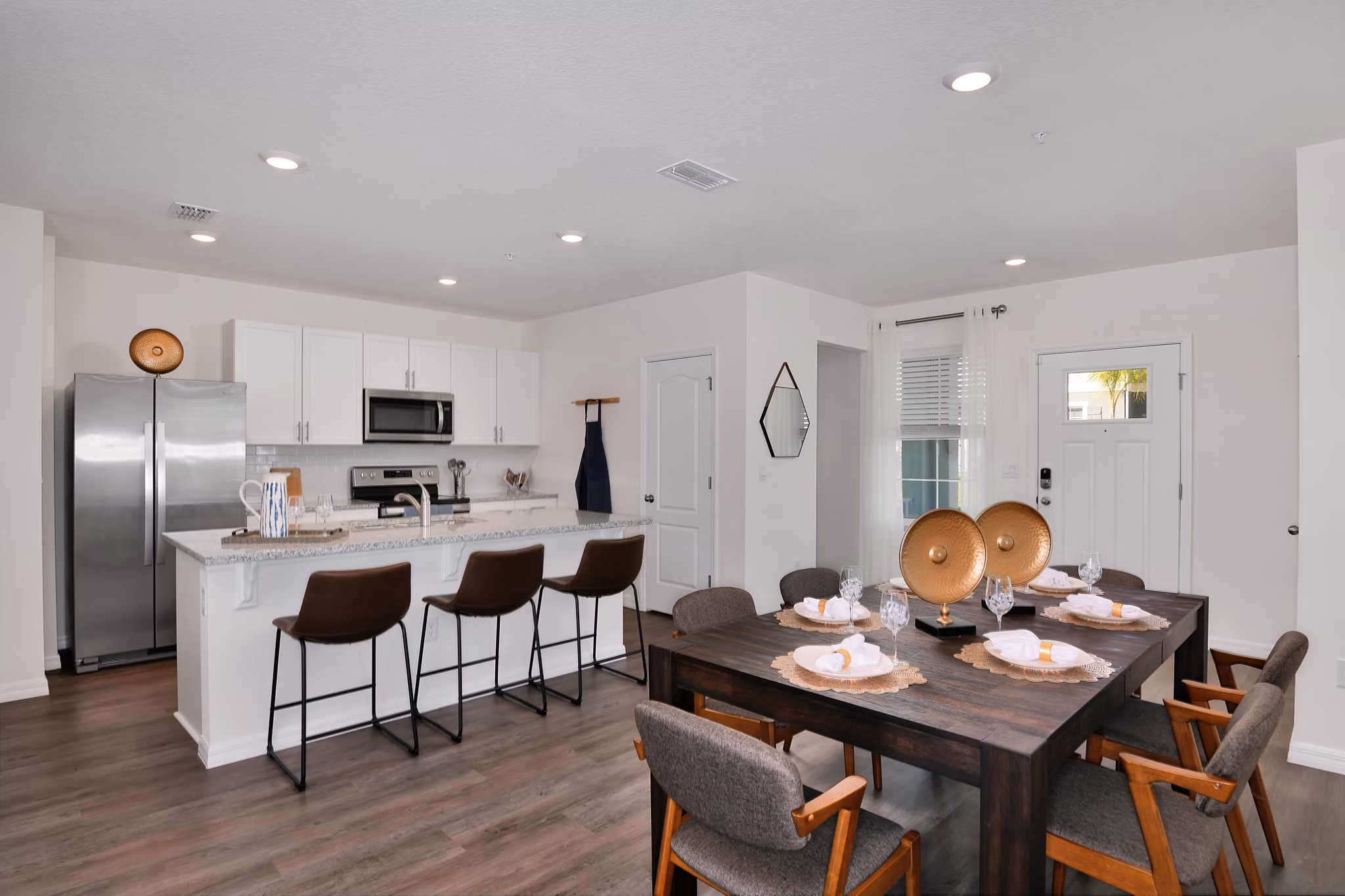 Dining area with modern furnishings at Summerwell Avian Pointe Apartments, featuring sleek design and elegant lighting