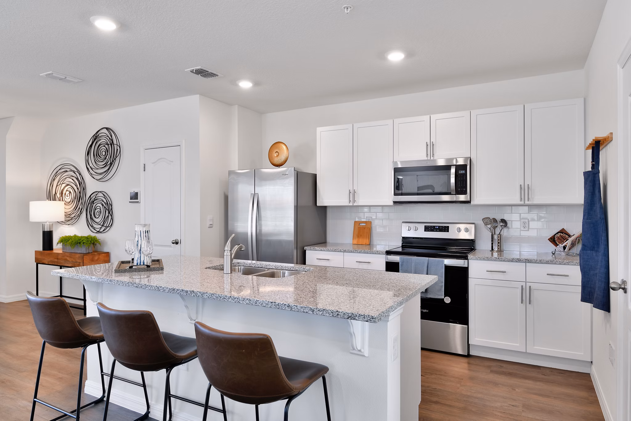 Modern kitchen with stainless steel appliances at Summerwell Avian Pointe Apartments