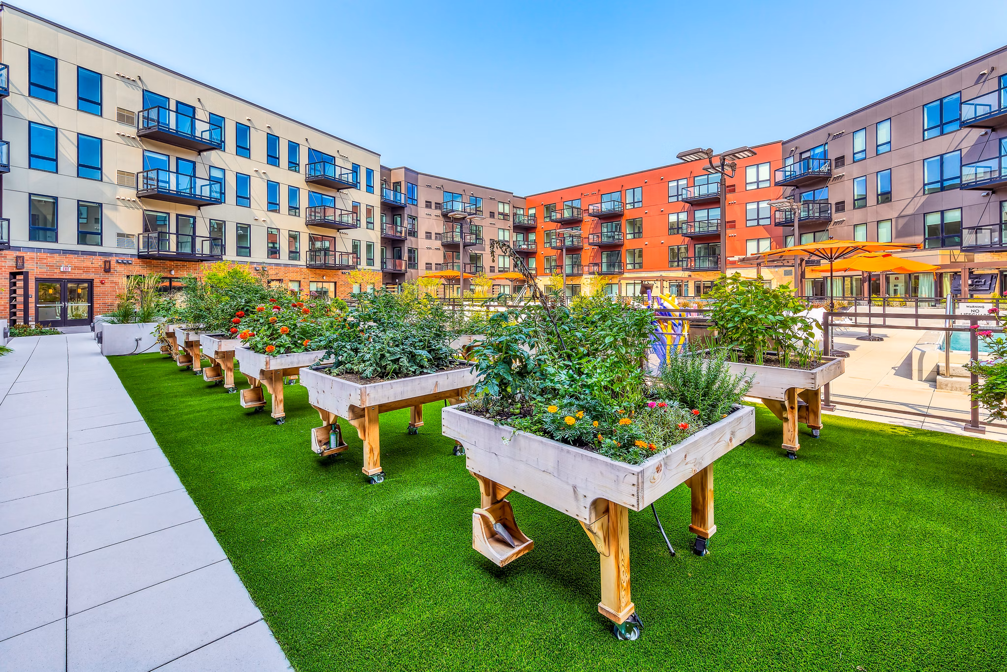 Avidor Glenview Apartments: Lush community garden with vibrant flowers and seating areas for relaxation