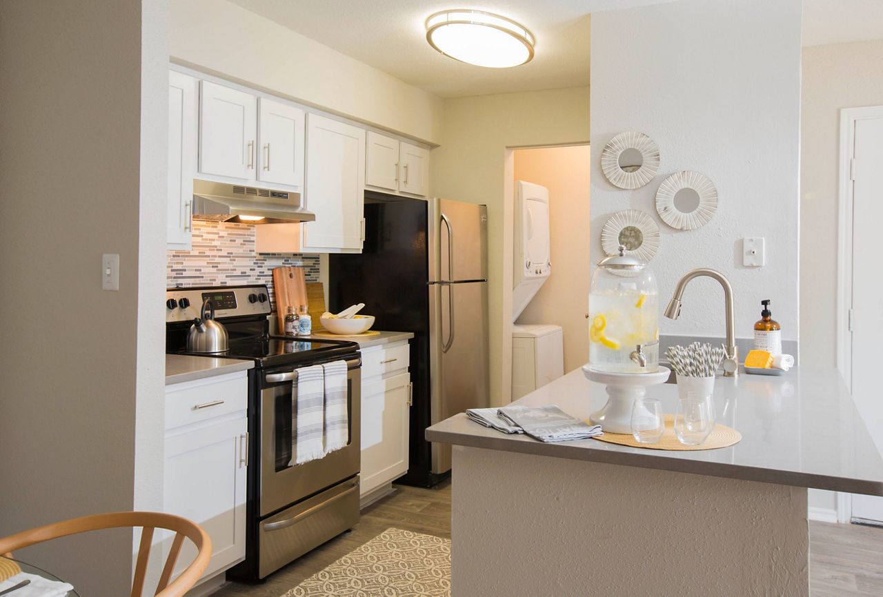 Modern kitchen featuring stainless steel appliances and granite countertops in Sherwood Crossing luxury apartments