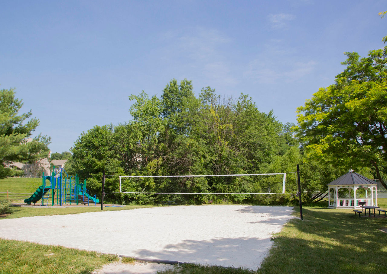 Volleyball court at Sherwood Crossing featuring nets and outdoor seating in this luxury apartment community