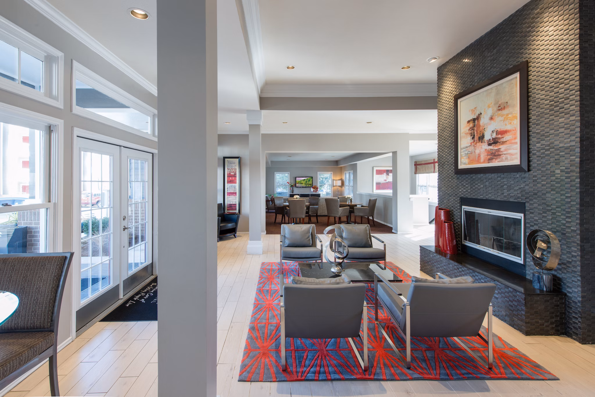 Modern clubhouse featuring lounge seating and large windows at Avana Red Run Apartments