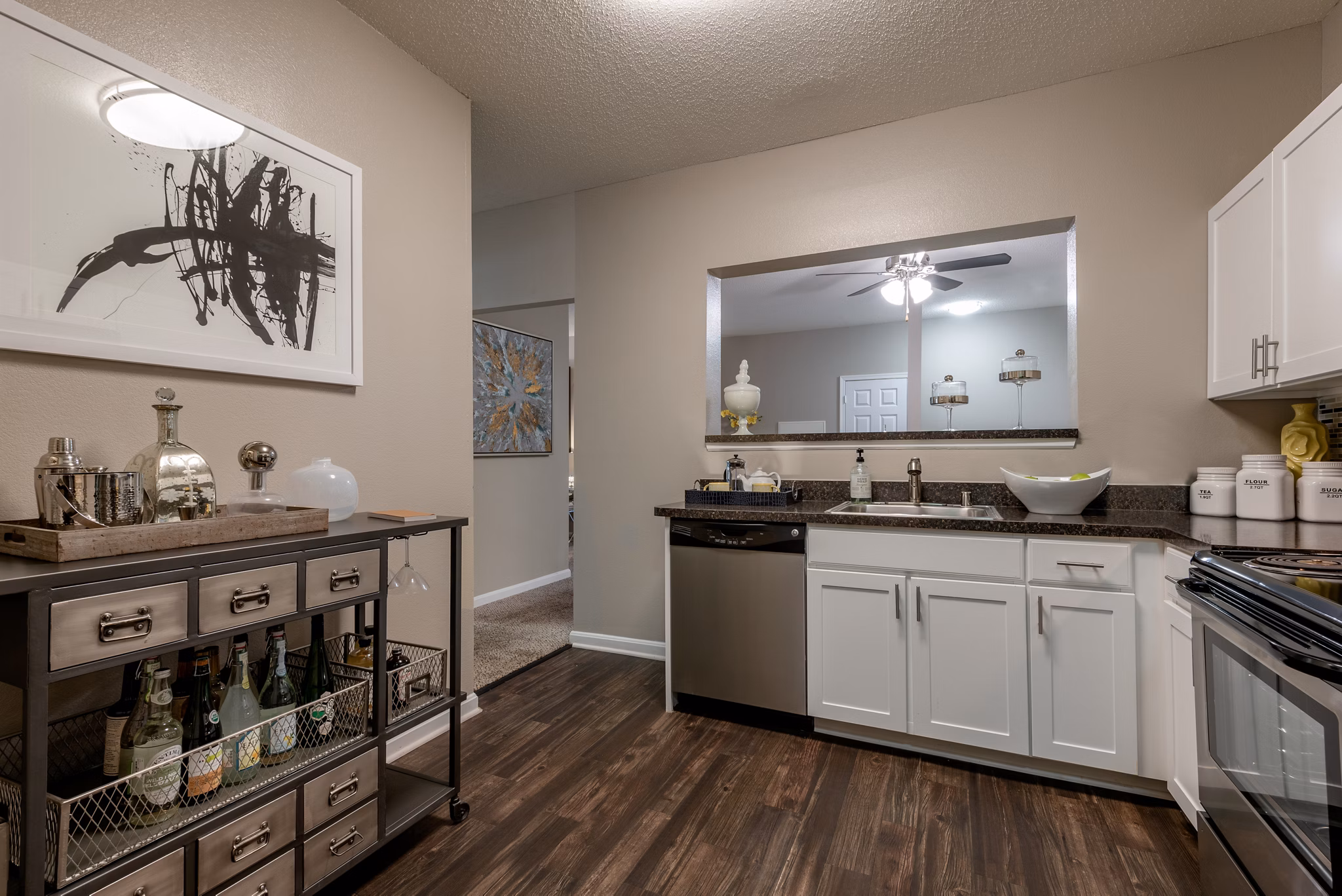 Modern kitchen with stainless steel appliances and granite countertops at Avana Red Run Apartments
