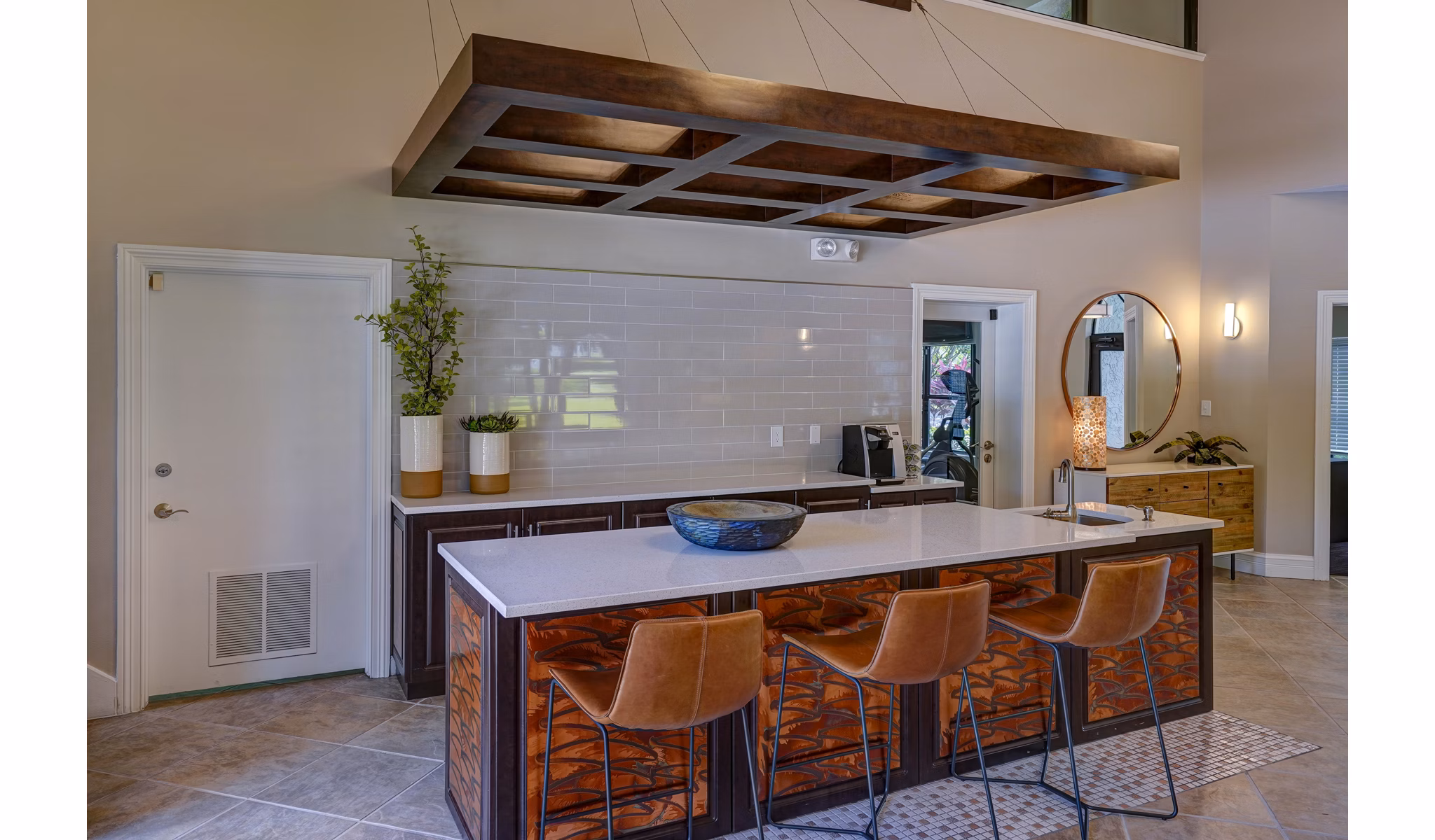 The Plantation Colony: Modern kitchen with island, bar stools, and pendant lighting in luxury Greystar apartments