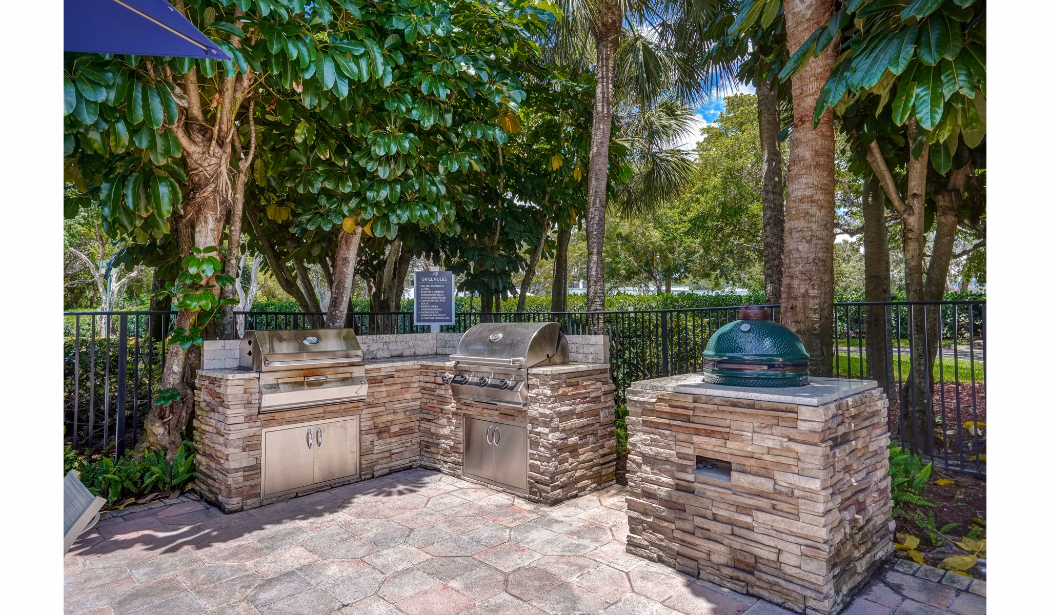 The Plantation Colony Apartments: Outdoor grilling area with stainless steel grills and smoker for luxury apartment residents
